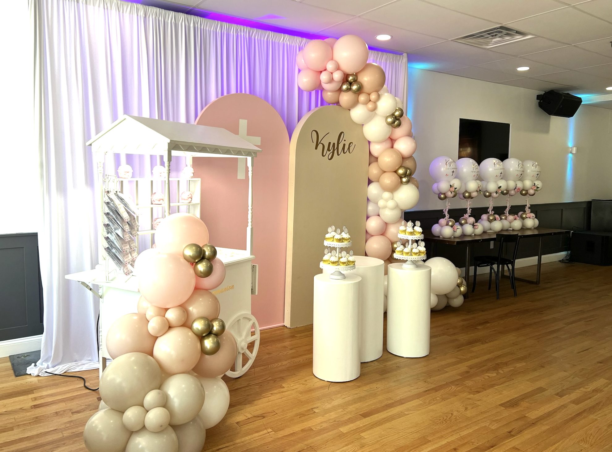Communion party setup with balloon arch and dessert cart in ECB's private dining room, Ridgewood, Queens