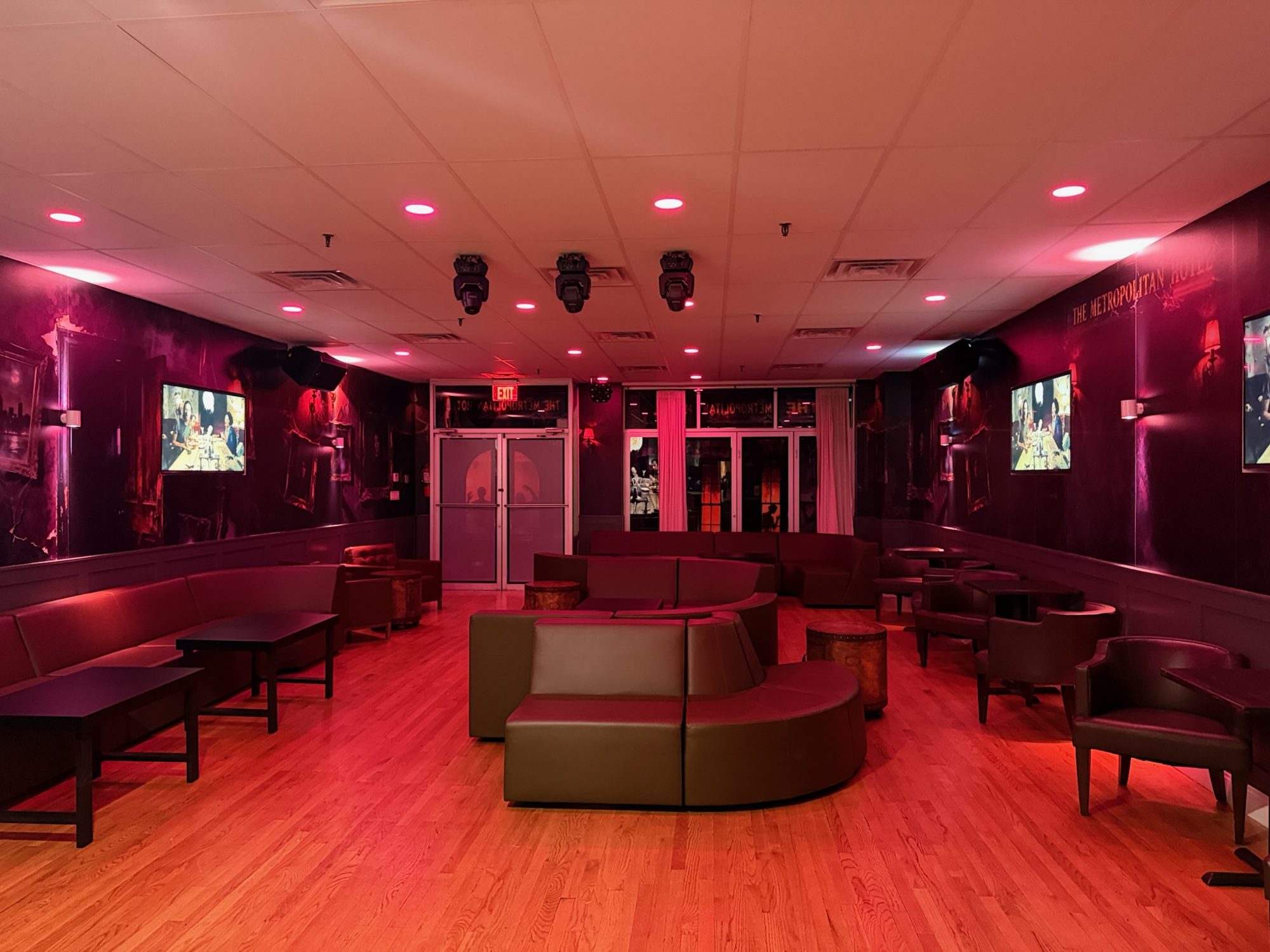 Lounge with leather couches in the private dining room at The Space Next Door by ECB, Ridgewood, Queens